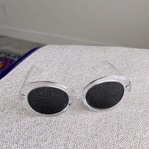 Sunglasses with clear frame and anthracite tint in retro style.